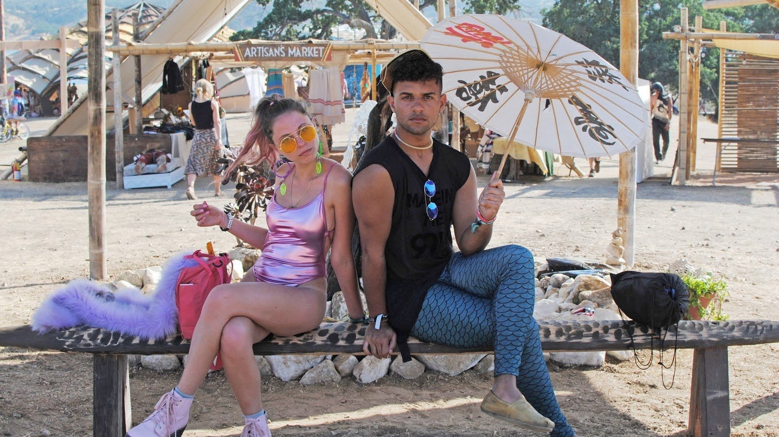 Girl in Pink Holographic Bodysuit with Neon Pink Combat Boots and Guy in Blue Mermaid Leggings during Lightning in a Bottle Music Festival