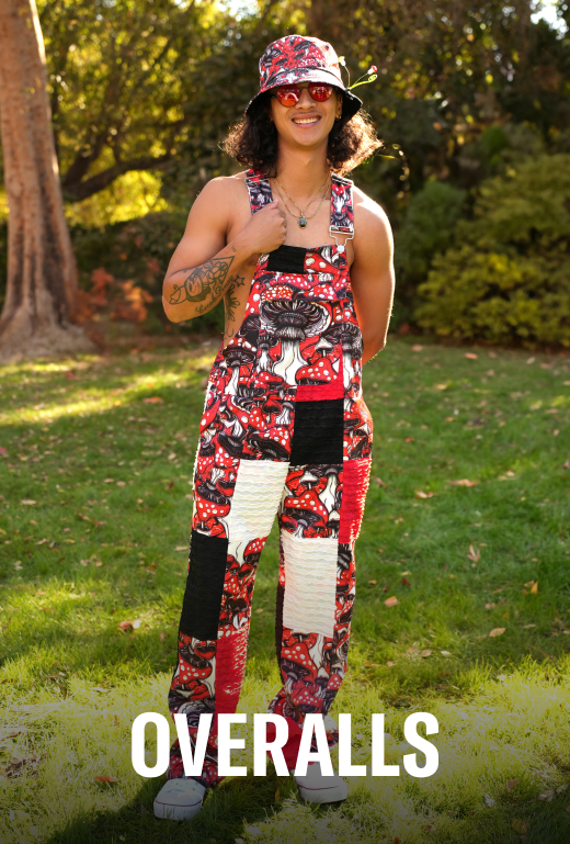 Person wearing a colorful patterned outfit with 'OVERALLS' text in a garden setting